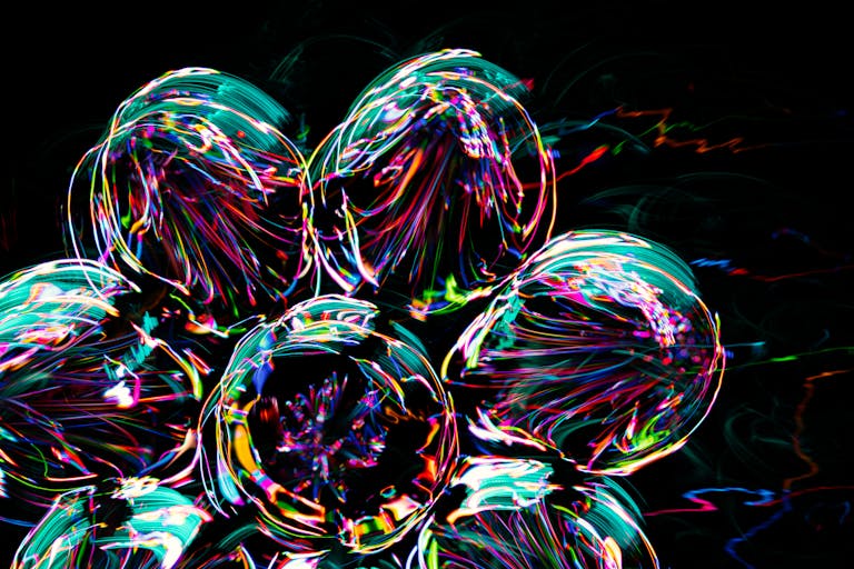 Colorful abstract circles with vivid patterns and reflections on a black background.