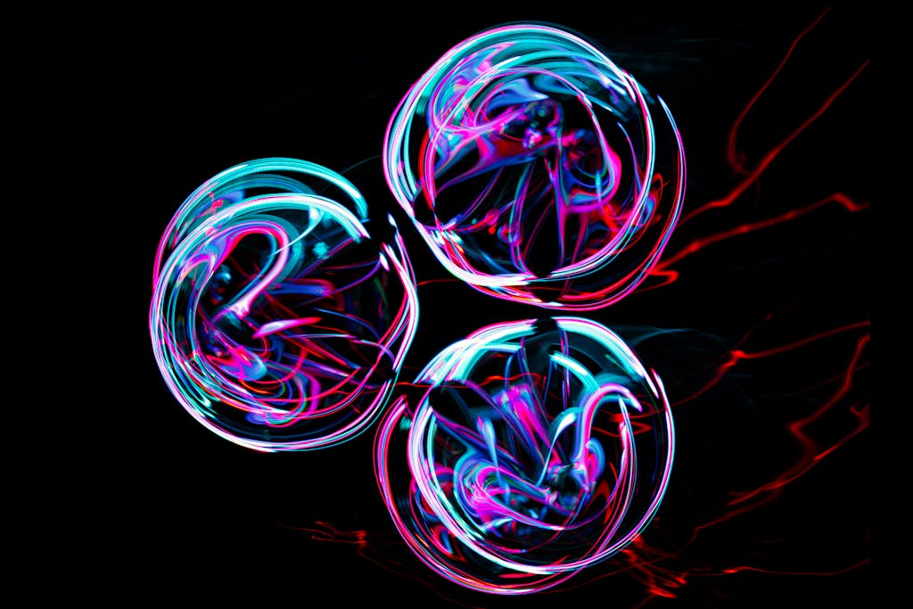 Vibrant abstract neon light circles creating a dynamic and colorful visual effect on a black background.